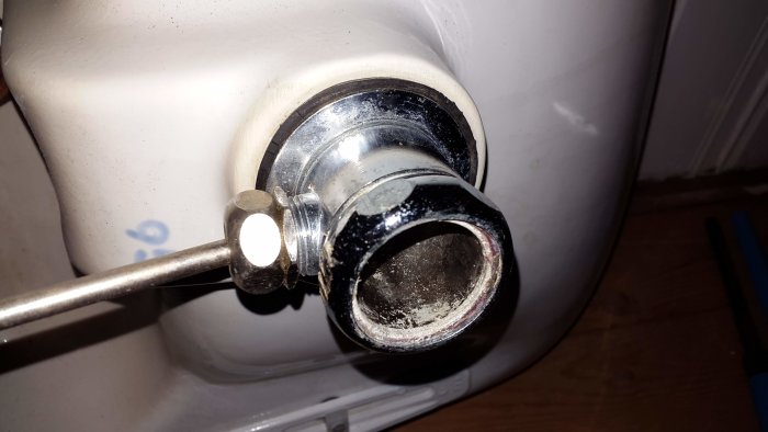 Rörtång används för att försöka öppna en kromad mutter på ett tvättställs avloppskoppling.