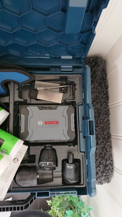 Bosch bitssats förvaras i ett verktygskoffert mellanfack med öppen lock.
