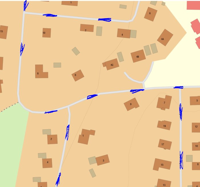 Karta från Lantmäteriet som visar ett område med orange mark och flera bruntonade byggnader, numrerade tomter och blåa linjer som kan vara vattendrag.