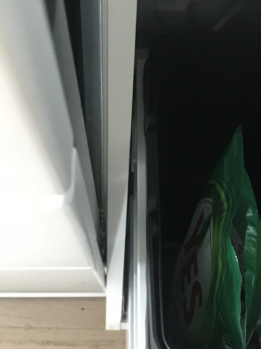 Diskmaskinslucka öppen med synlig trång passage nära skåpsstommen, indikerar plats där den tar i.