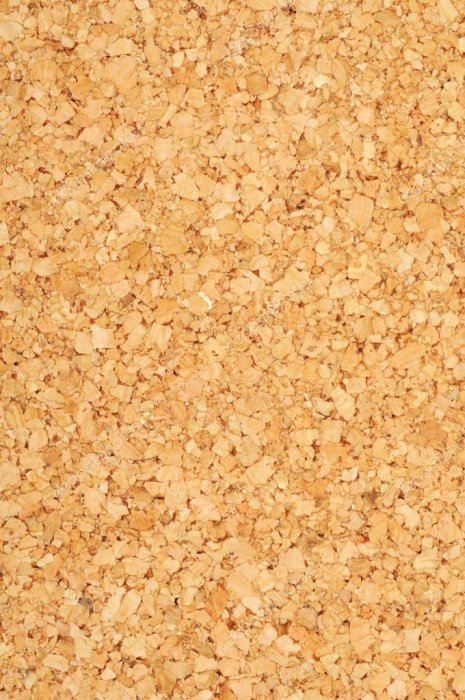 Närbild av Korkoplast golvbeläggning med små bitar av kork synliga under ett genomskinligt plastlager.