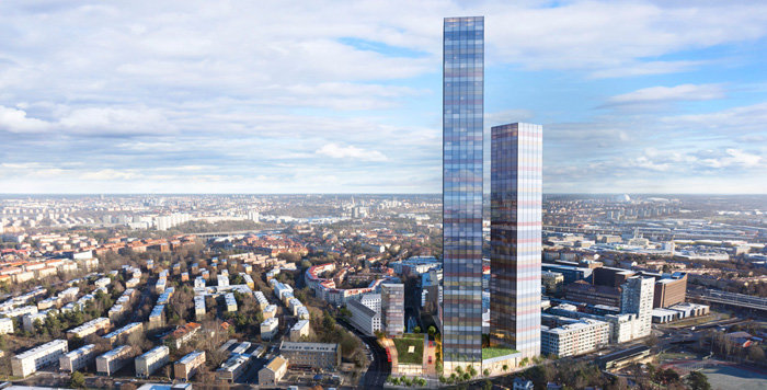 Renderad bild av planerade "twin towers" skyskrapor mot en stadssilhuett i dagsljus.