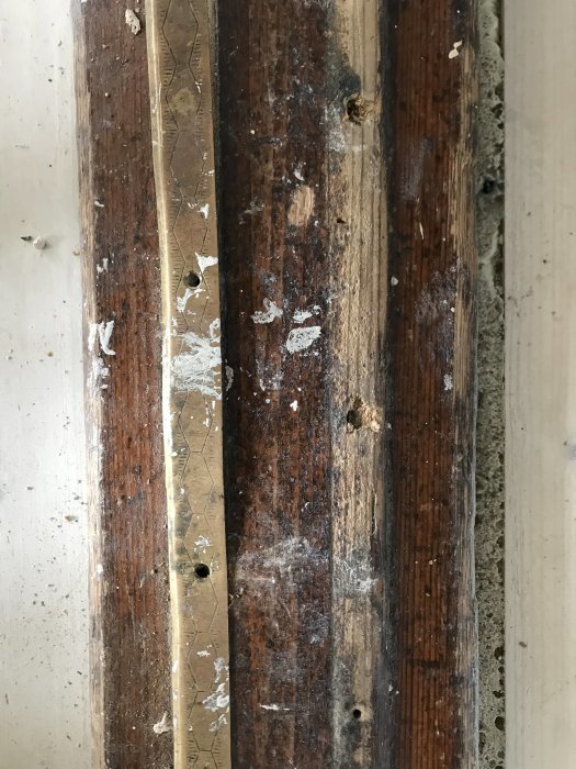 Renoverad tröskellist där gammal färg slipats bort, poleras nu fram för ett slätt och rent utseende.