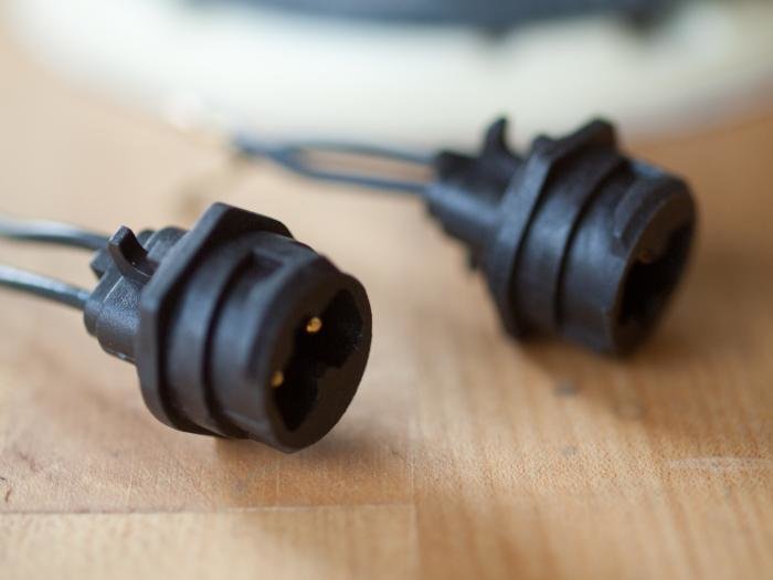 Två svarta elkontakter för anslutning, en med tre stift synlig, nära en vit yta. Festool #489926