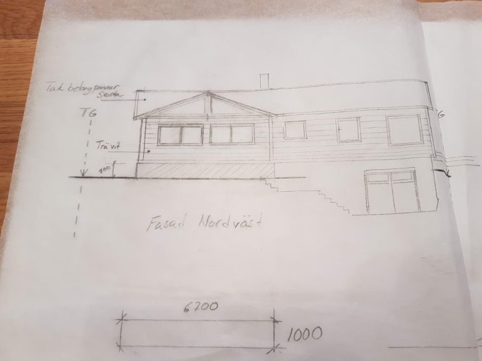 Handritad skiss av ett hus med dimensioner som avser en utbyggnad.