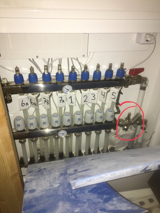 Värmesystem med flera termostatventiler, en ringad i rött är fylld med vatten, andra har kondens.