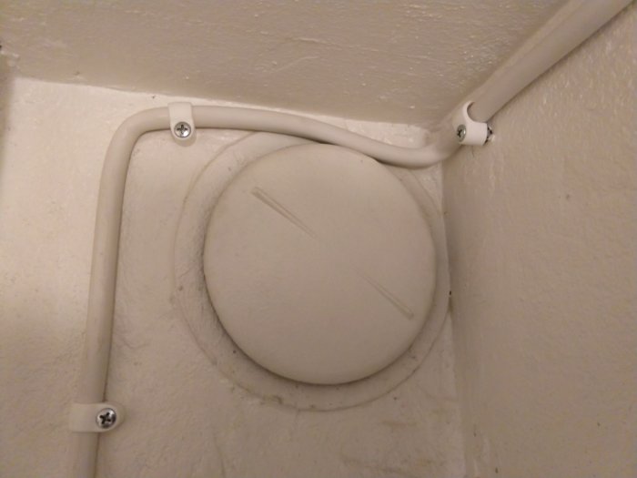 Elektrisk kabel dragen ojämnt över en ventil och inte längs med takvinkeln med klumpiga klamrar.