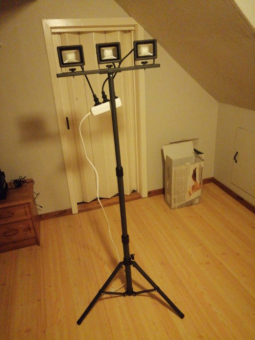 Stativ med tre tända 10W strålkastare i ett inomhusrum, installationsmöjlighet under.