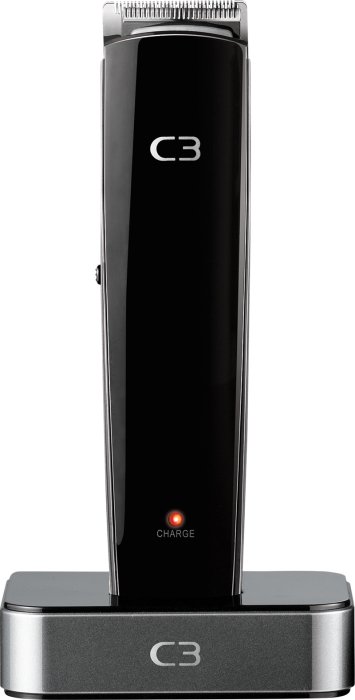 Batteridriven hårklippare av märket C3 på laddningsstation med laddningsindikator tänt.