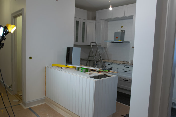 Renovering av kök med skåp under konstruktion och verktyg på bänken.