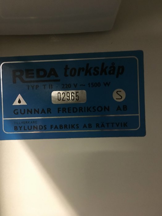 Typskylt på REDA torkskåp med specificeringar Typ TIII, 220V, 1500W, serienummer 02965 och tillverkare Bylunds Fabriks AB Rättvik.