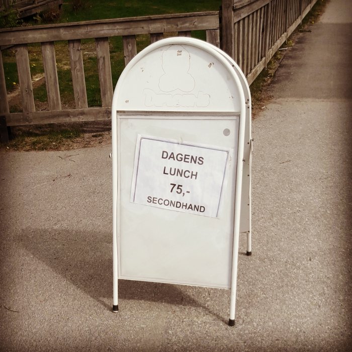 Skylt med texten "DAGENS LUNCH 75,- SECONHAND" utomhus, humoristisk felstavning av secondhand.