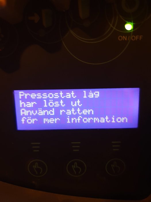 Display på apparat visar felkoden "Pressostat. lag har löst ut. Använd rätten för mer information" med ON/OFF-knapp.