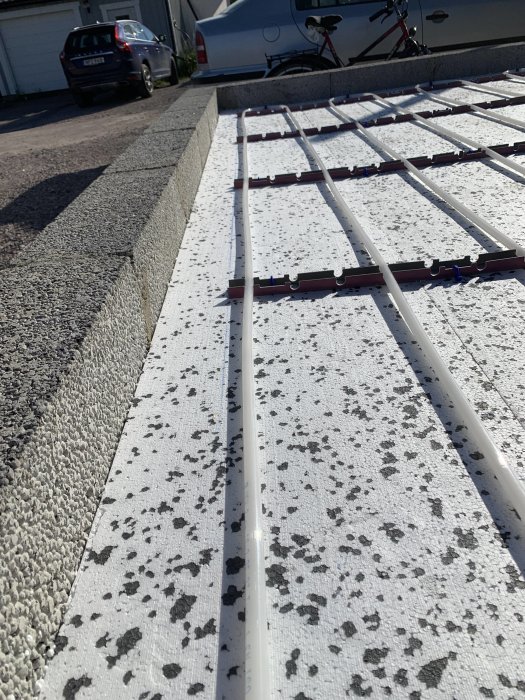 Isolering med golvärmeinstallation framför lecablock väntandes på betonggjutning.