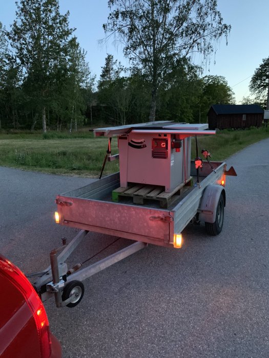 Ny Hammer B3 Winner Comfort-maskin transporterad på ett släp parkerat vid vägkanten i skymningen.