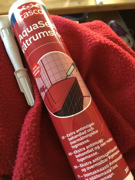 Casco Aquaseal våtrumsfog-tub mot röd handduk, används för fogning vid köksrenovering.