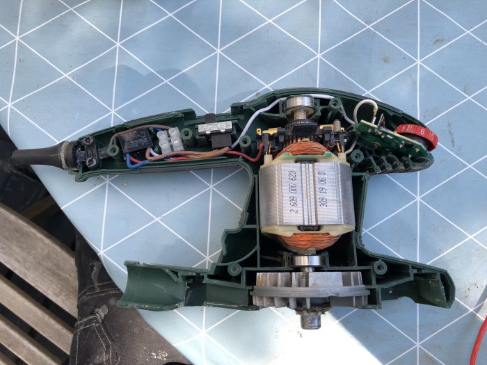 Öppnad Bosch PSS 250 AE slipmaskin med synligt kretskort och hastighetsreglage.
