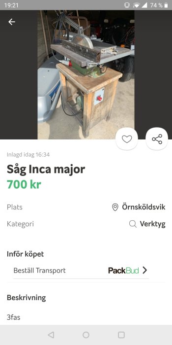 Inca major bordsåg till salu, placerad på ett träbord i ett garage, omgiven av verktyg och fordon.