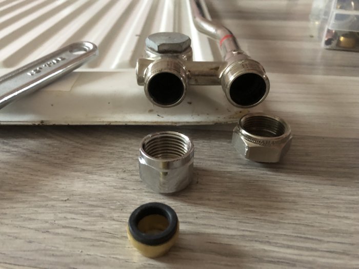 Kopplingsdelar på träyta inklusive ett element, 12 mm halvkoppling och 20 mm gammal koppling.