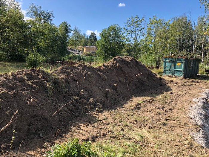 Excess soil heaps and a container on a construction site in Haninge, Stockholm.