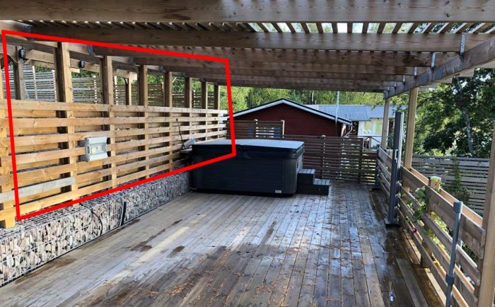 Carport som övergår till altan med Jacuzzi, trägolv, och öppen plankvägg markerad för renovering.