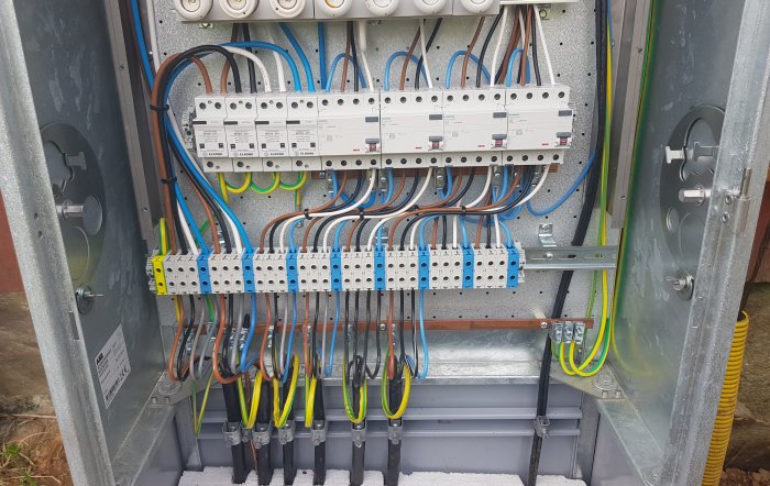 Elektrisk fördelningsskåp med säkringar, kablage och anslutningspunkter för en solcellsanläggning.