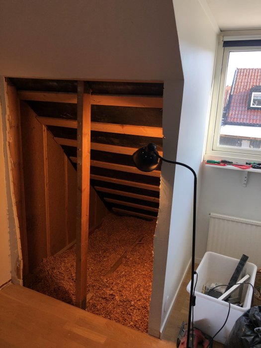 Renoveringsprojekt där en kattvind öppnats upp vid takkupa i ett 60-tals hus med synliga takstolar och spillvirke.