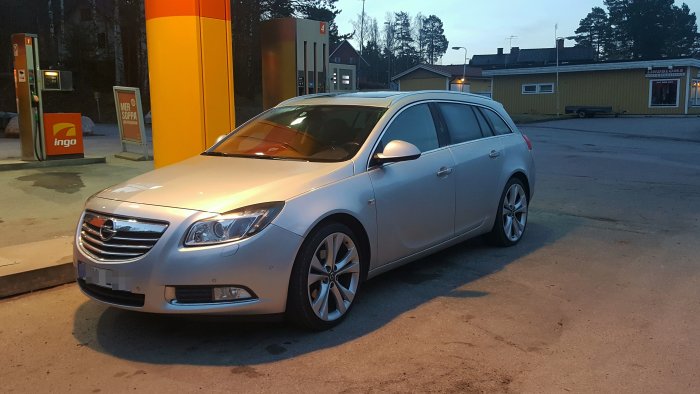 Opel Insignia 2011 4x4 station wagon parked at a gas station in the evening.