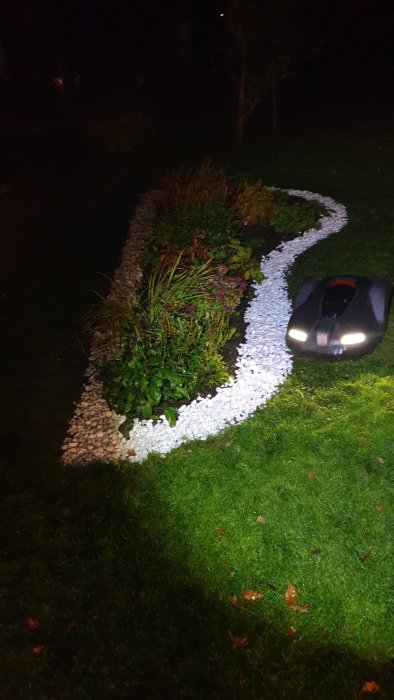 Robotic lawn mower 'Bruce' navigating a garden at night with a visible path and grass area.