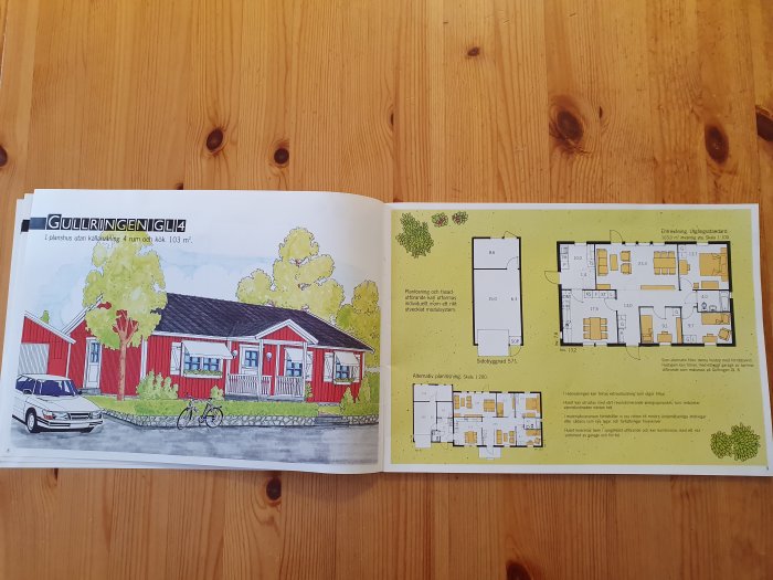 Öppnad huskatalog som visar ritningen av ett rött hus med planlösningar.