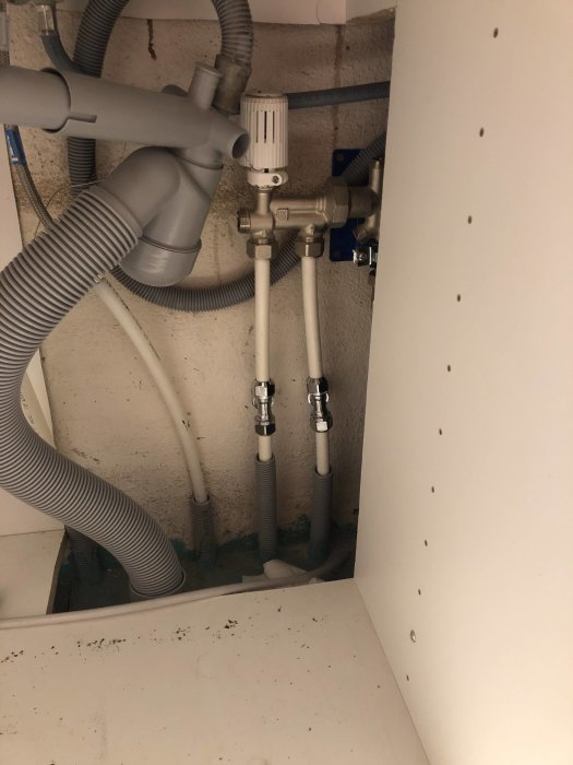 Installation av rör och ventiler för golvvärme och radiator i källarutrymme.