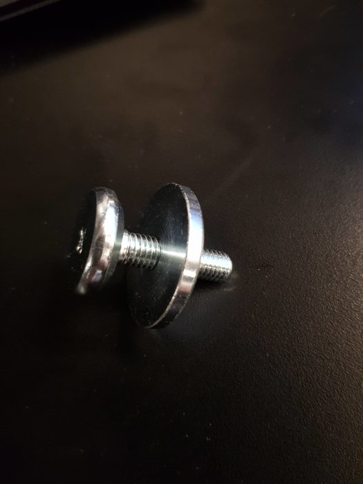 Metallskruv med bricka på mörk bakgrund, användare söker längre variant.