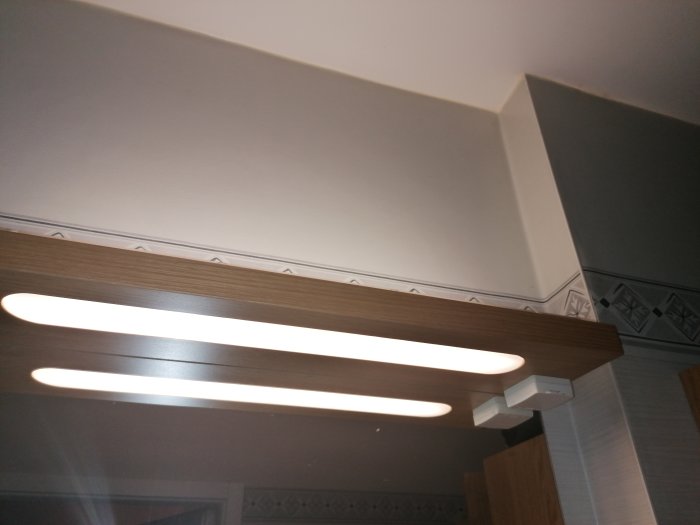 Lysrör ovanför en badrumsspegel som kan bytas ut mot LED-tejp.