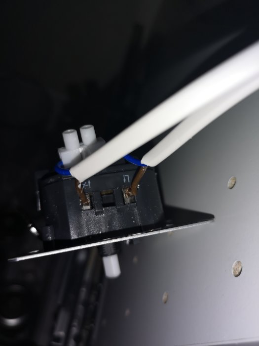Elkontakt med trådar kopplade till dimmer, fas och nolla är synliga.
