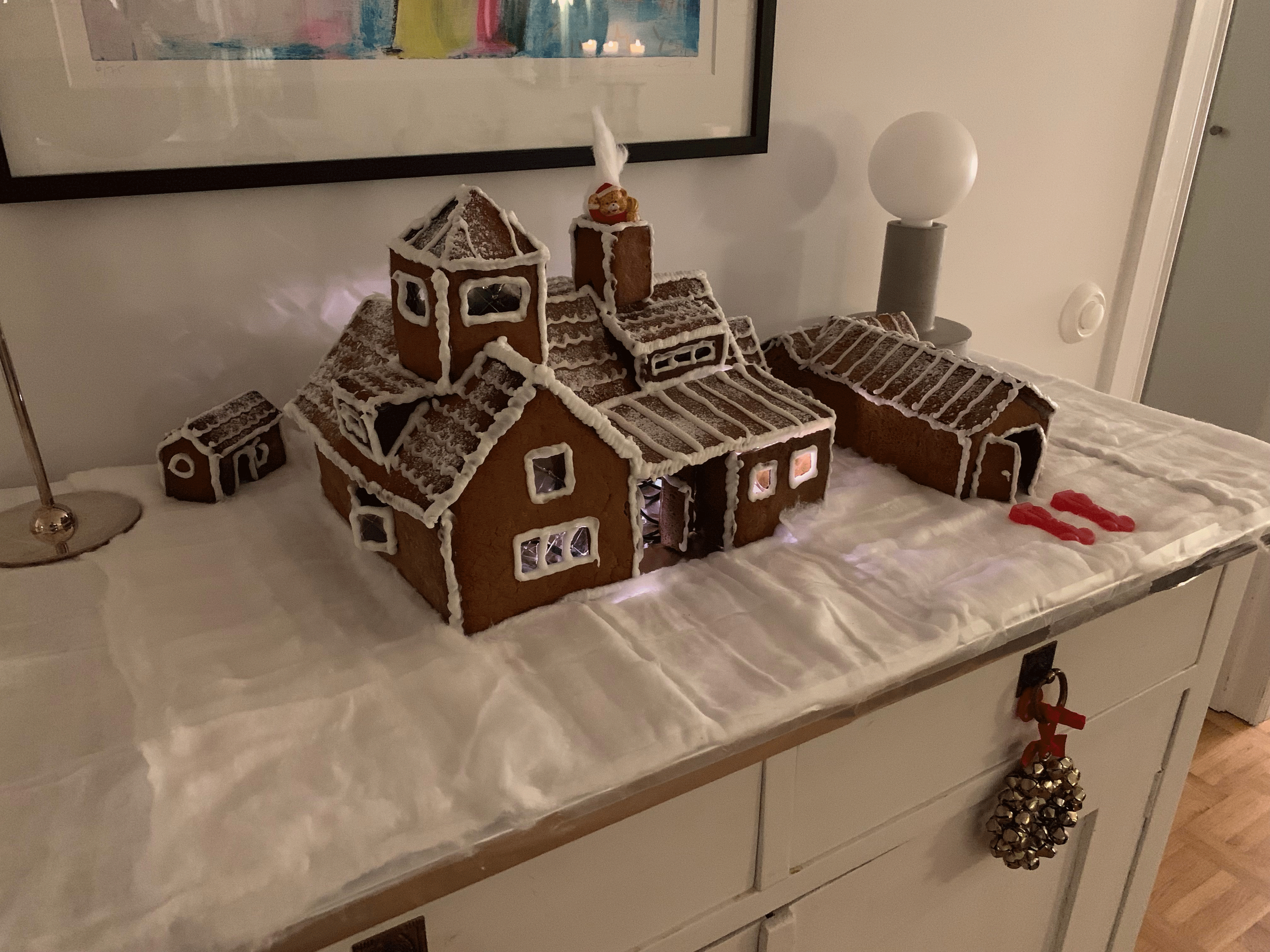 Pepparkakshus som föreställer Lomma kyrka, uppställd på ett bord med vita vaddunderlag.