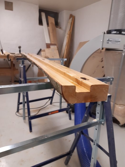 Hyvlad och slipad björkplanka behandlad med hårdvaxolja, avsedd för en hylla, i ett verkstadsrum.