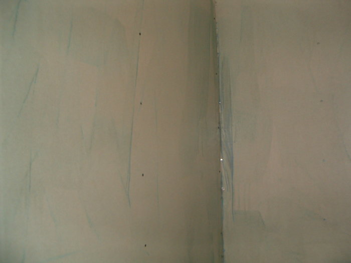 Gipsvägg under konstruktion med synliga skarvar och skruvhål.