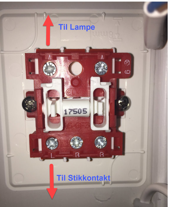 Bakifrån bild på en öppen 1-polig väggströmställare med ledningar och pilmarkeringar.