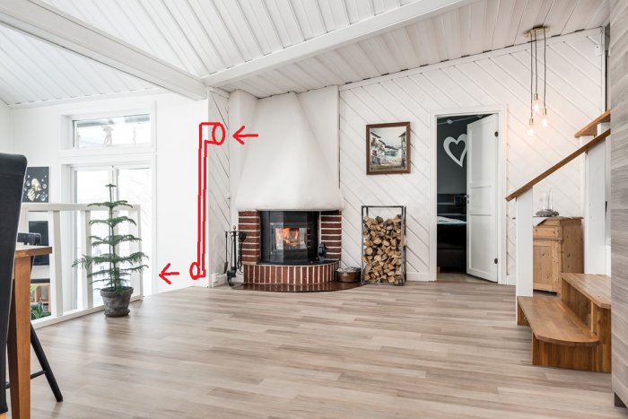 Inredning med kamin och trappa där rött diagram visar planerad dragning av spirorör för luftcirkulation.