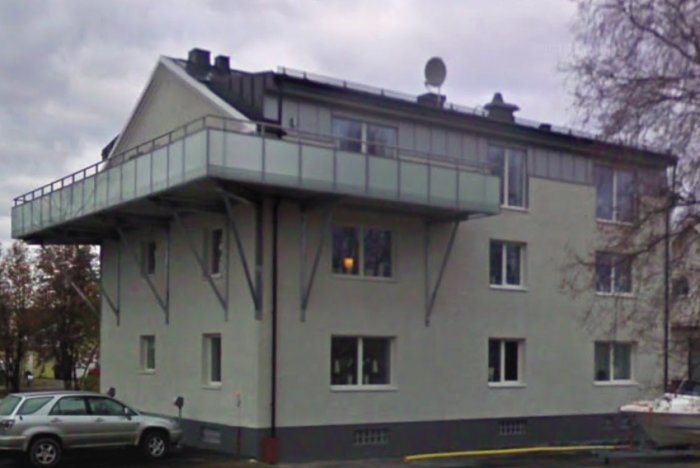 Modern balkong på ett äldre hus i historiskt område, ifrågasatt av byggnadsnämnden.