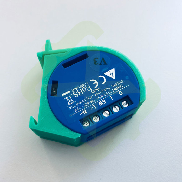 Blå och grön elektronisk komponent med text och symboler, avsedd för montering med DIN-fästen.