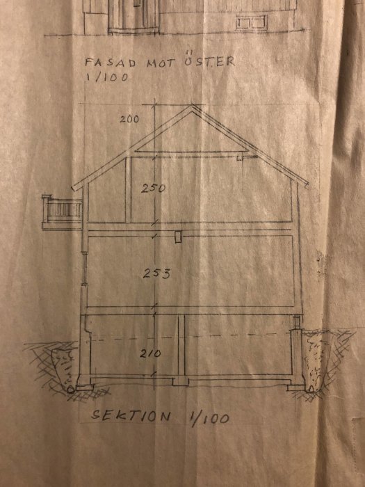 Arkitektritning av hussektion med markerade mått och en vägg markerad i rött, planerad ny vägg indikerad med blå streck.