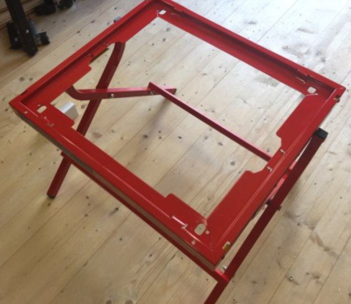 Rött Bosch GTA-6000 sågstativ i bra skick på ett trägolv.