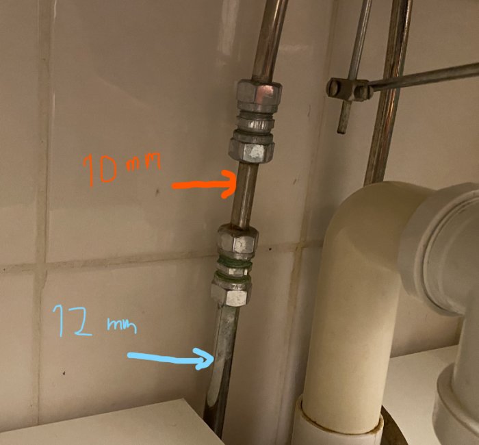 Ett anslutningsrör för tvättställ med två klämringskopplingar, markerat med 10 mm respektive 12 mm dimension.