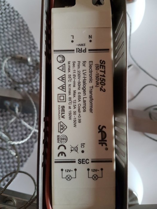 Inbyggt transformator för halogenlampor märkt SET1502, elektriska specifikationer och säkerhetsikoner syns.