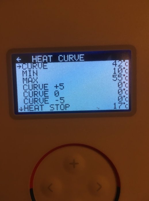 Digital display of a heating system's settings showing the 'HEAT CURVE' with multiple numeric values, surrounded by control buttons.