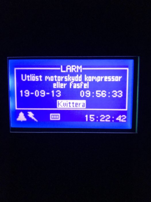 Display på värmepump som visar ett larm för utlöst motorskydd kompressor eller felfunktion.