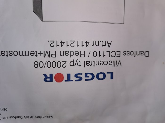 Upside-down view of a white paper with the inverted text "ISOPOR" and some blurry text.