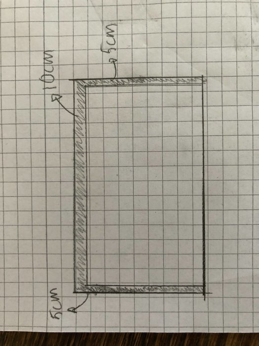 Handritad skiss av en utbyggnadsgrund på rutat papper där grunden är markerad 10cm större än utbyggnaden.