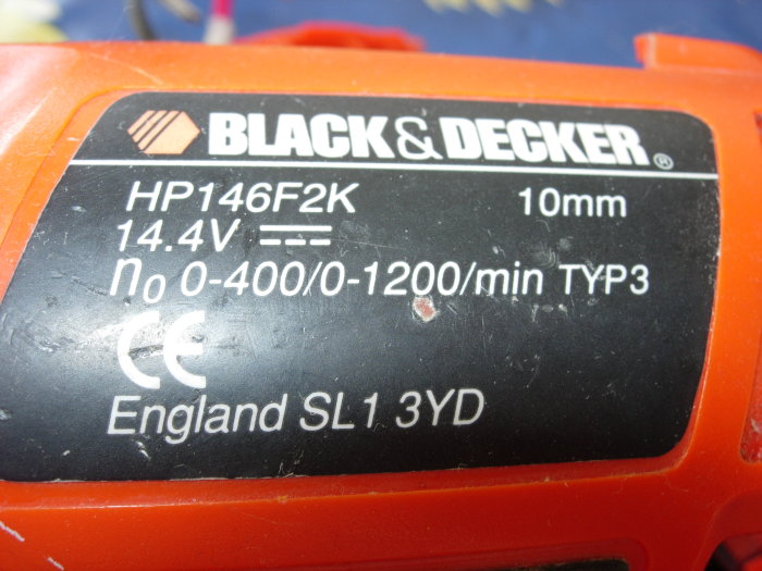 Närbild på Black & Decker borr med modellnummer HP146F2K och specifikationer, fokus på rödmärkt motor.